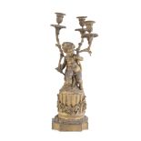 A FRENCH THREE LIGTH GILT METAL CANDLEABRA, 19th century, cast as a cherub holding three scrolling