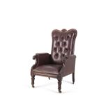 A GEORGE IV MAHOGANY FRAMED LIBRARY ARMCHAIR, upholstered in red buttoned hide, with gently out-