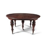 A FINE VICTORIAN MAHOGANY CIRCULAR EXTENDING DINING TABLE, the moulded rim raised on baluster turned