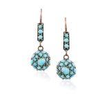 A PAIR OF TURQUOISE PENDENT EARRINGS, formed as stylised florettes with large central stone and
