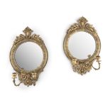 A PAIR OF 19TH CENTURY GILT GESSO CIRCULAR GIRANDOLE MIRRORS, surmounted with foliate cresting, with