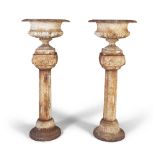 A PAIR OF VICTORIAN CAST IRON GARDEN URNS AND PEDESTALS, each of classical design with out-turned