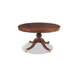 A CIRCULAR MAHOGANY TABLE, raised on turned centre pillar and four splayed legs with brass