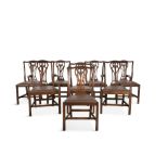 A SET OF EIGHT MAHOGANY FRAMED DINING CHAIRS, in the Georgian taste, the crest rail above carved and