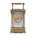 A FRENCH GILT BRASS TRAVEL CLOCK, 19th century, in original fitted case, surmounted with reeded