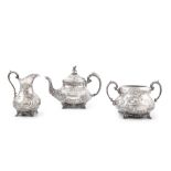 A THREE PIECE SILVER TEA SERVICE, Sheffield, 1862, mark of Martin, Hall & Co., of compressed