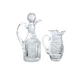 A CUT GLASS CLARET JUG AND STOPPER, the body cut with a series of diamonds and slices with faceted