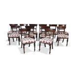 A SET OF TWELVE GEORGE IV STYLE MAHOGANY FRAMED DINING CHAIRS, with curved rail backs padded seats