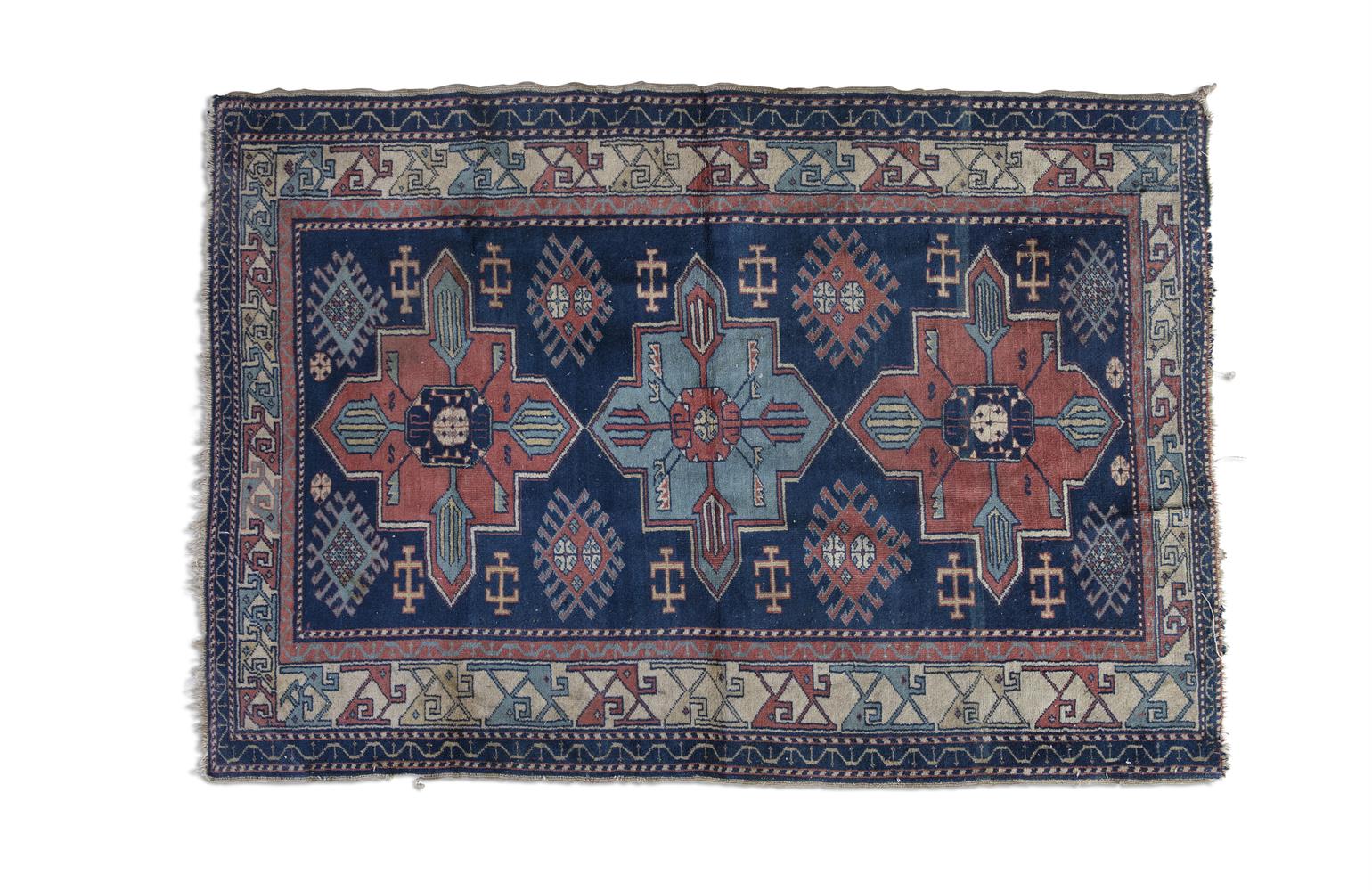 A KAZAK WOOL RUG, EARLY 20TH CENTURY, rectangular field woven with three central geometric