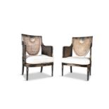 A SMALL EDWARDIAN JAPANNED BERGÈRE SUITE, consisting of a settee and two armchairs, each with cane-