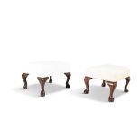 TWO SMALL MAHOGANY FRAMED FOOT STOOLS, with cream upholstery and raised on cabriole supports. Each
