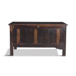 A FRUITWOOD BLANKET CHEST, 18TH CENTURY, of panelled form with hinged top on squared supports.