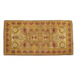 A DUN EMER HEARTH RUG, of rectangular form, woven with an oval stylised motif and set with