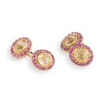 A PAIR OF CITRINE AND RUBY CUFFLINKS, double sided, with cushion-shaped citrine, each within a