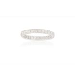 A DIAMOND ETERNITY RING, CIRCA 1950The continuous row of single-cut diamonds, with engraved scroll