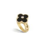 AN 'ALHAMBRA' RING, BY VAN CLEEF & ARPELSThe polished onyx plaque of quatrefoil design, centrally-