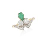 AN EARLY 20TH CENTURY EMERALD AND DIAMOND RINGThe kite-shaped emerald set between two old