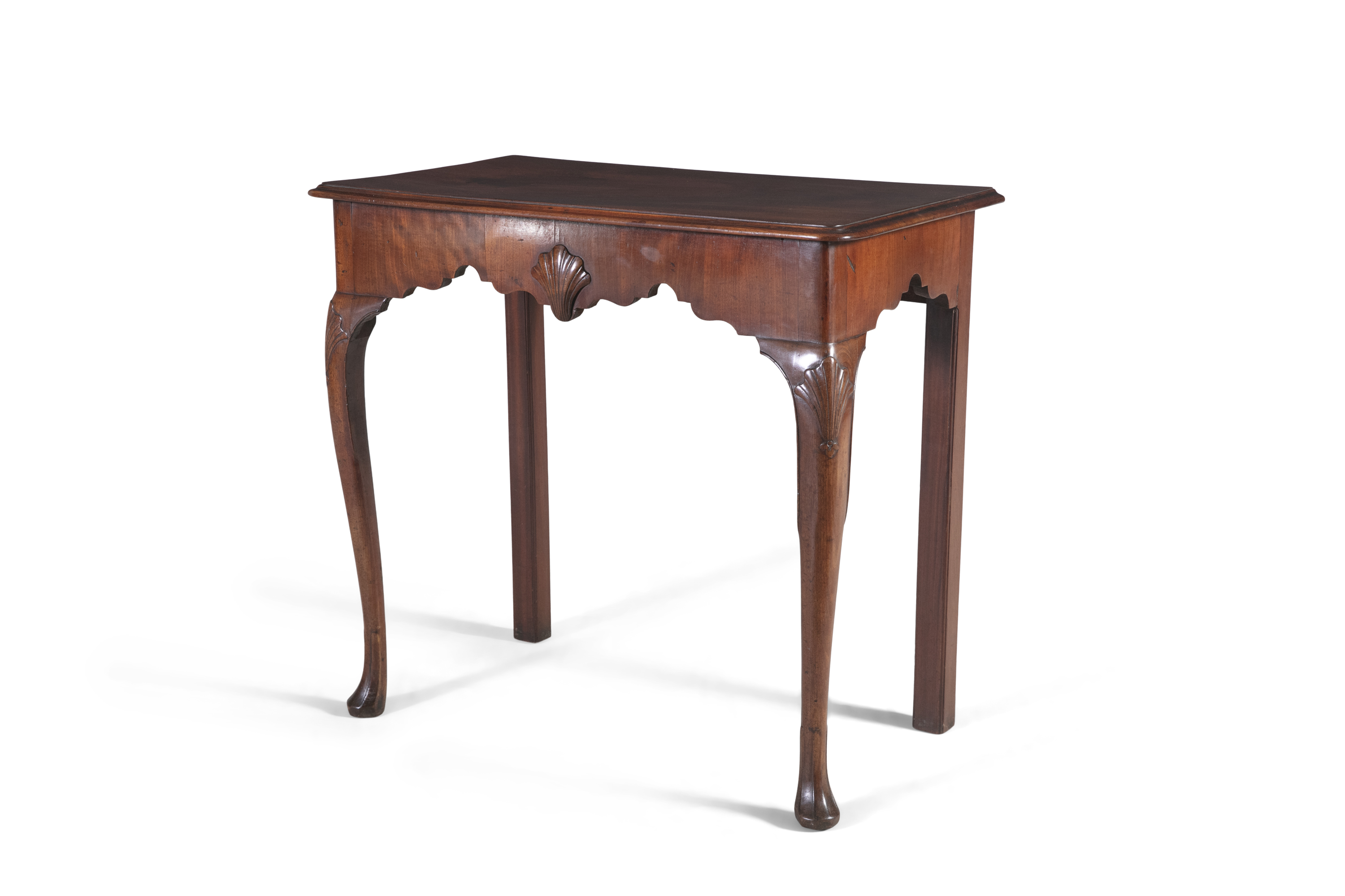 AN IRISH GEORGE III MAHOGANY SIDE TABLE , with plain moulded top, and shaped frieze centred with a