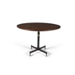 A circular teak table by Gio Ponti produced by Radice, on brass casters supported by a telescope