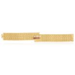 A DIAMOND, RUBY AND GOLD BRACELET, CIRCA 1960The highly articulated fancy-link mesh bracelet, with