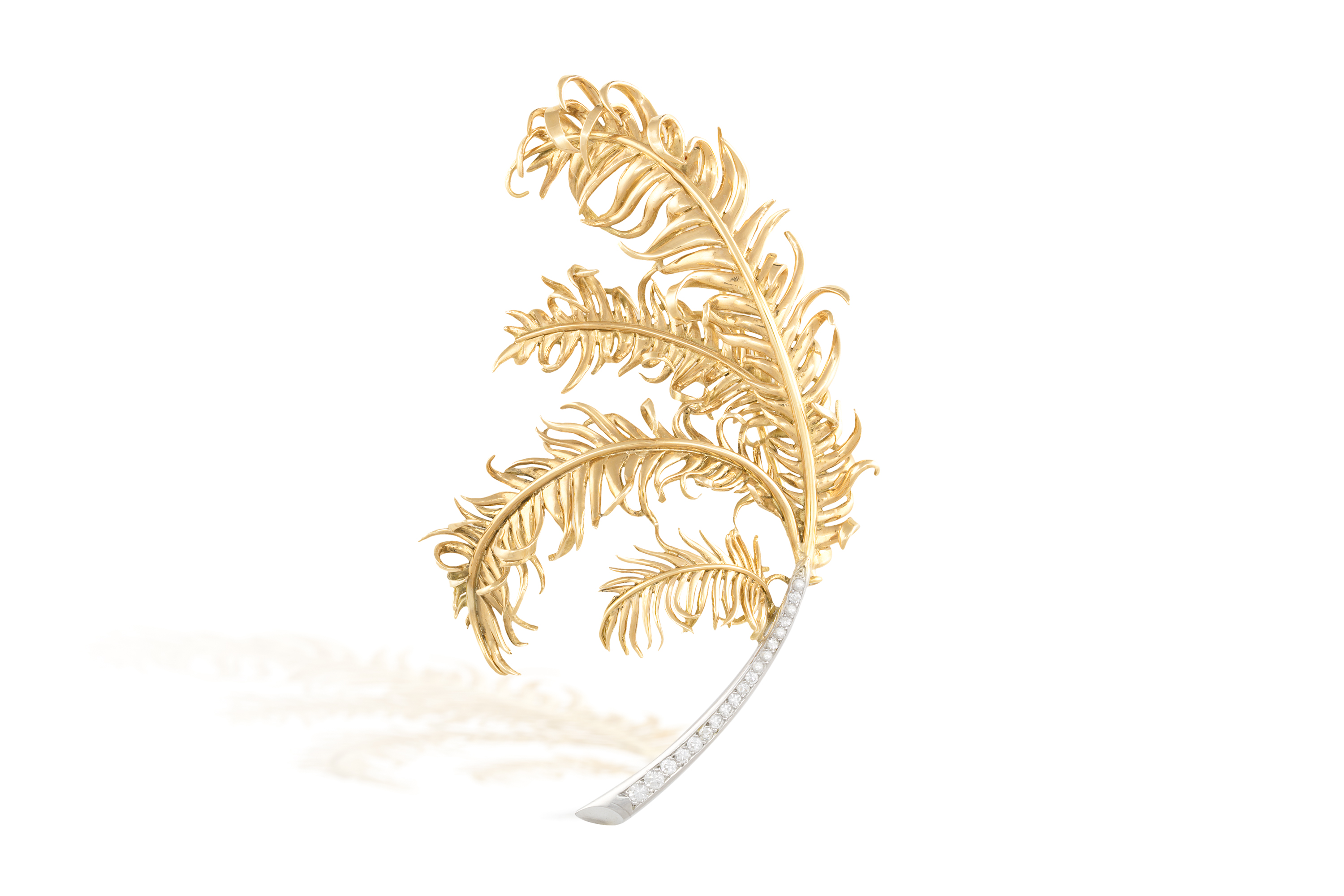 A GOLD AND DIAMOND BROOCH, CIRCA 1960Designed as a stylised feather spray, embellished with a