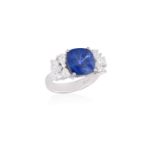 A SAPPHIRE AND DIAMOND RINGThe cushion-shaped sapphire weighing approximately 8.00cts, within a