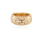 A DIAMOND AND GOLD PARENTESI RING, BY BULGARI, CIRCA 1985The polished hoop with reeded decoration,