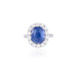 A SAPPHIRE AND DIAMOND CLUSTER RINGThe cushion-shaped sapphire weighing 4.56cts, within a surround