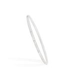 A DIAMOND BANGLE, BY TIFFANY & CO.The thin hoop accented with round brilliant-cut diamonds