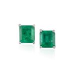 A PAIR OF EMERALD EARSTUDSEach rectangular-shaped emerald within a four-claw setting, weighing