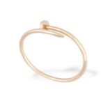A GOLD JUSTE UN CLOU BANGLE, BY CARTIERDesigned as a hinged wraparound nail, in 18K rose gold,