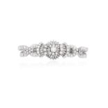 A DIAMOND COCKTAIL BRACELET, CIRCA 1960The cluster of round brilliant and baguette-cut diamonds,