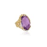 AN AMETHYST AND DIAMOND COCKTAIL RING, CIRCA 1970The large oval-shaped amethyst, set within an