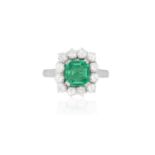 A FINE EMERALD AND DIAMOND CLUSTER RINGThe rectangular cut-cornered emerald weighing 1.51cts, within