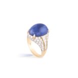 A SAPPHIRE AND DIAMOND TROMBINO RING, BY BULGARIThe cabochon sapphire, weighing 11.90cts, between