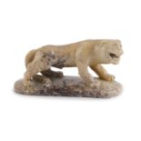 A CARVED SOAPSTONE MODEL OF A PROWLING LIONESS, probably Chinese, 15cms long