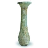 Esenciero en vidrio romano, co iridiscencias. S. II DC. Medidas: 9 cm Acompaña peana de