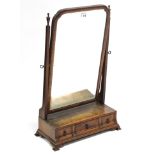 A George I-style walnut rectangular swing dressing table mirror, fitted three small drawers & on