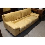 A Tetrad tan leather three-seater settee with loose cushions to seat, & on short square legs, 76”