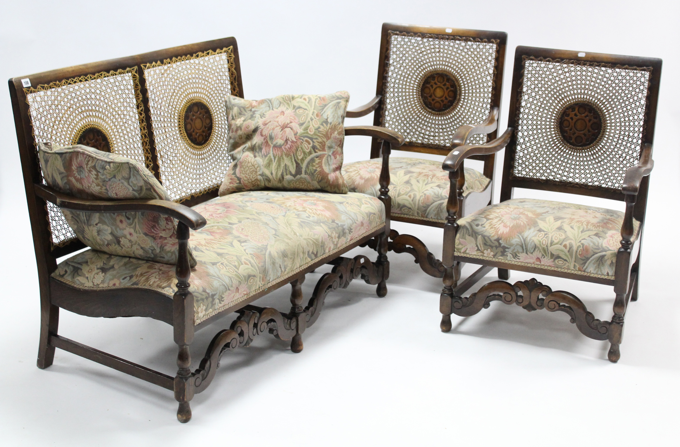 An early-mid 20th century oak-frame three-piece lounge suite comprising a two-seater settee inset