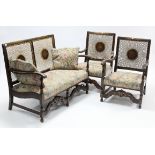 An early-mid 20th century oak-frame three-piece lounge suite comprising a two-seater settee inset