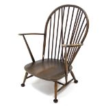 An Ercol spindle-back elbow chair, with hard seat & on short round tapered legs with spindle