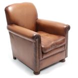 A tan leather & brass-studded armchair.