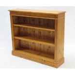 A pine three-tier standing open bookcase on plinth base, 49¾” wide x 42” high.