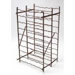 A wrought-iron standing wine rack, 22” wide x 40” high; & a black leatherette revolving chair.