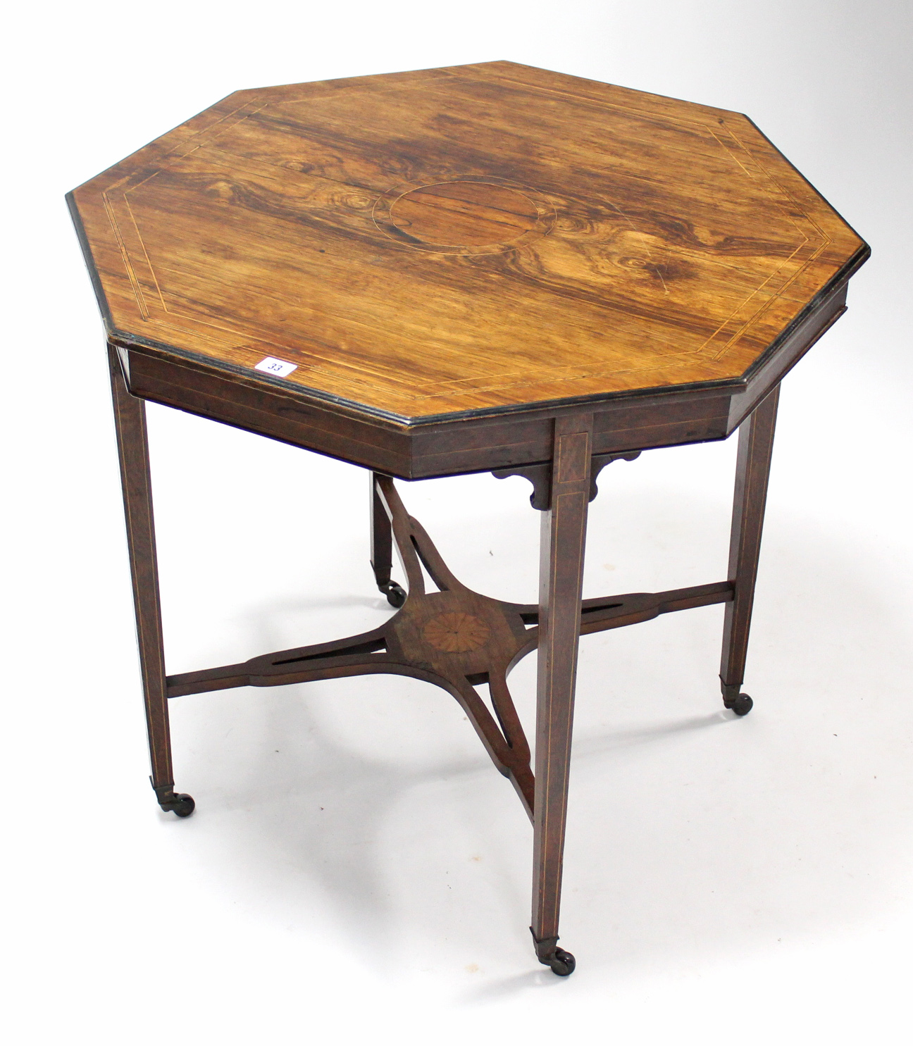 A 19th century inlaid rosewood octagonal centre table on square tapered legs & ceramic castors, with