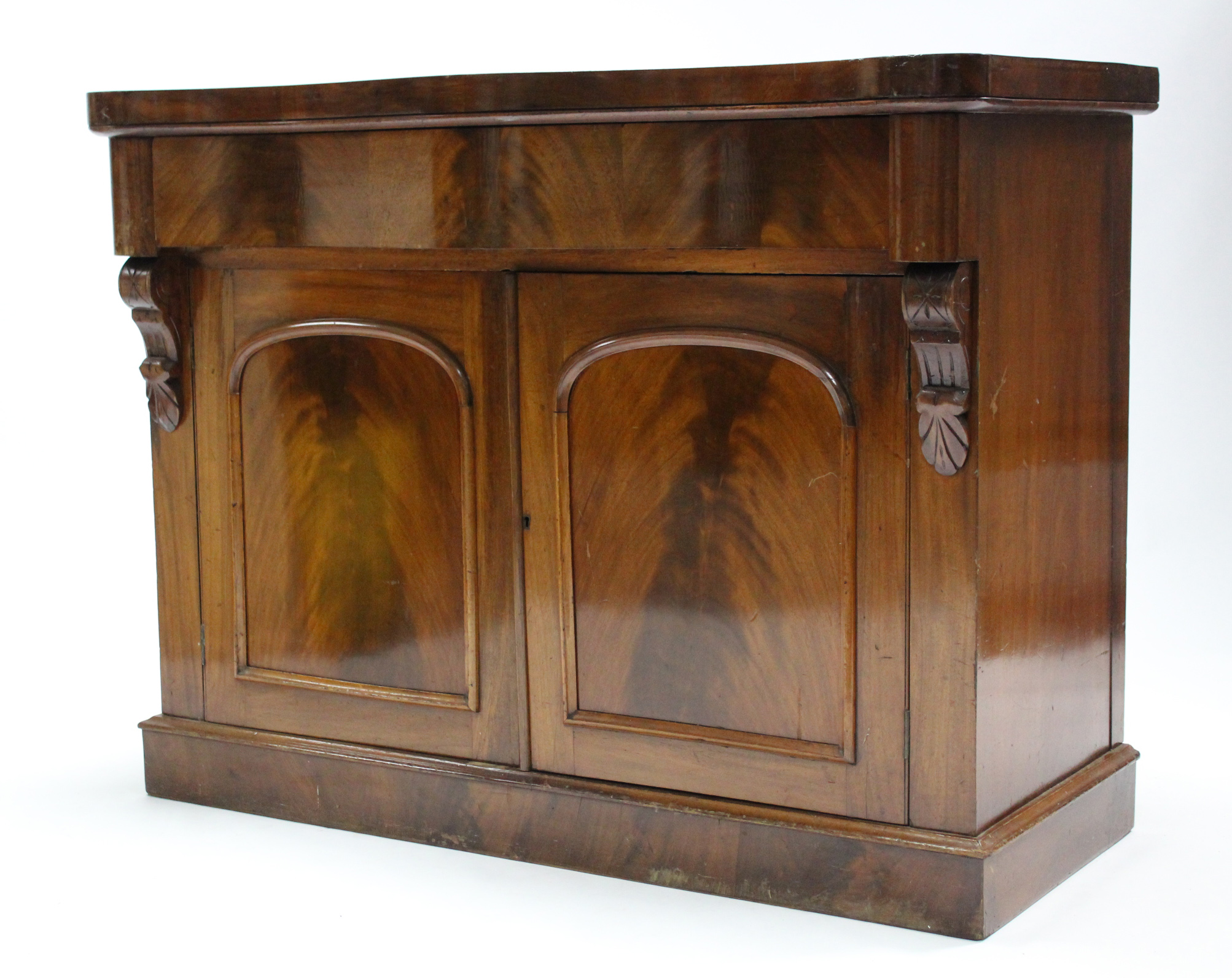 A 19th century mahogany serpentine-front chiffonier, fitted frieze drawer above cupboard enclosed by