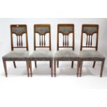 A set of four Edwardian inlaid-mahogany spindle-back dining chairs with sprung seats, & on square