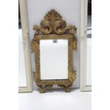 A small rectangular wall mirror in carved giltwood frame, 22” x 17¼”, w.a.f. together with three