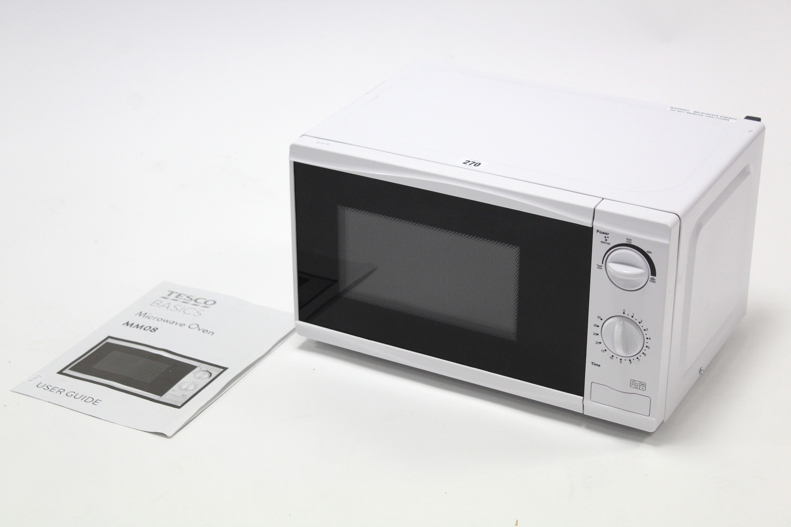 A Tesco 700W microwave oven in white finish case.